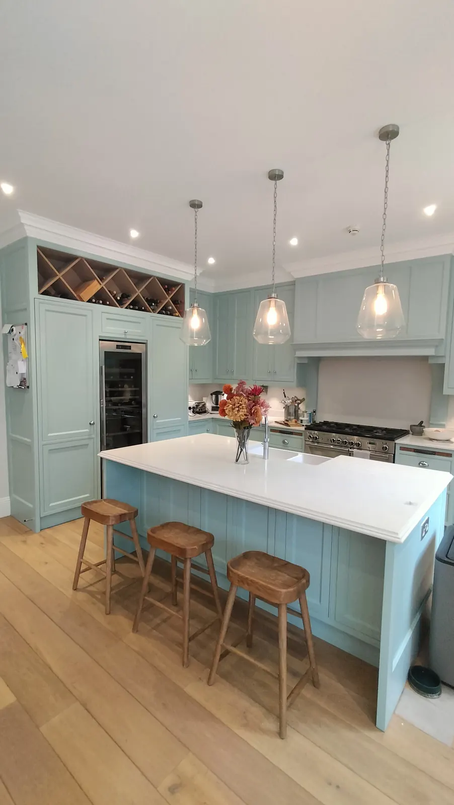 Duck-egg island kitchen with breakfast bar and pendant lights, resprayed in Hampshire