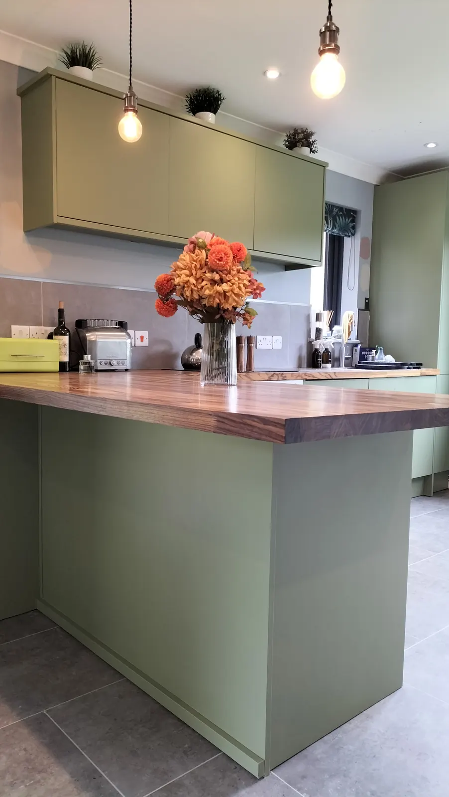 Sage green island with wooden worktop and pendant lights &mdash; kitchen respray in Hampshire by Kitchen Decorators