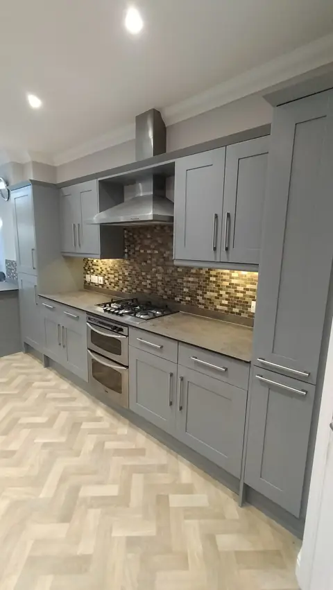 Soft grey kitchen with a herringbone floor
