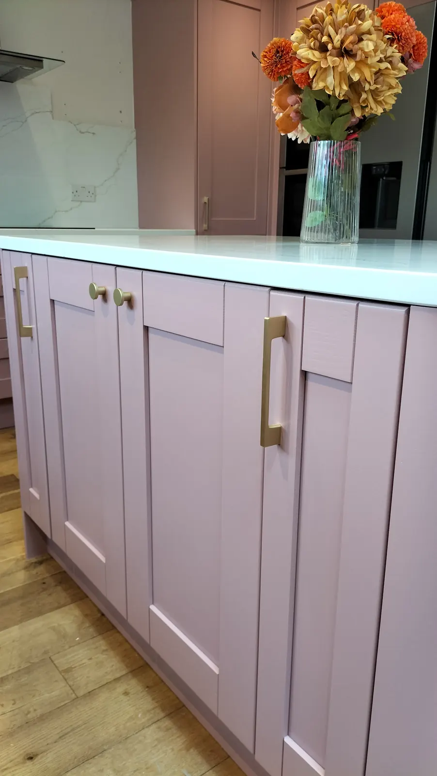 Dusky pink island with brass bar handles &mdash; kitchen respray in Hampshire by Kitchen Decorators
