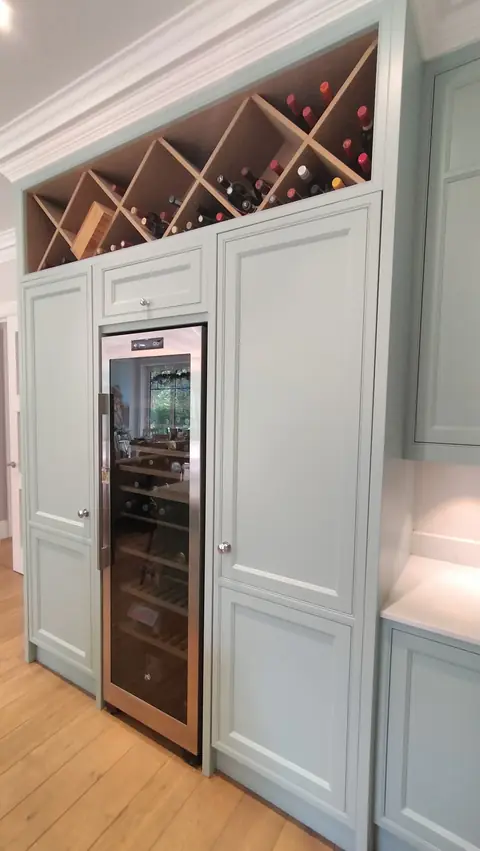 Duck-egg tall larder units with a built-in wine rack and wine cooler