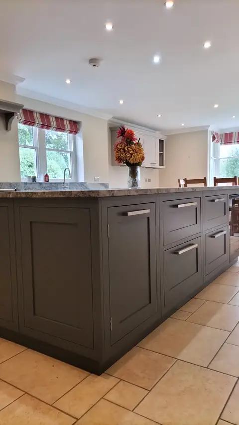Charcoal painted island on a stone tiled floor